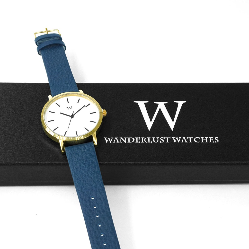 Reloj de Pulsera Wanderlust, Esfera Blanca con correa azul y negra - Dorado